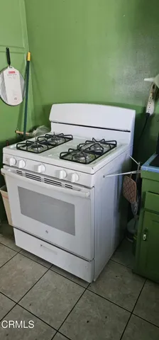 a stove top oven sitting inside of a kitchen