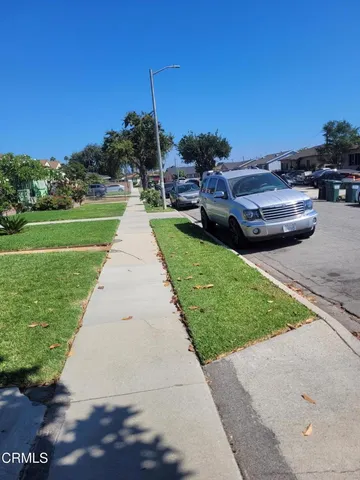 a park view with a bench and lawn chairs