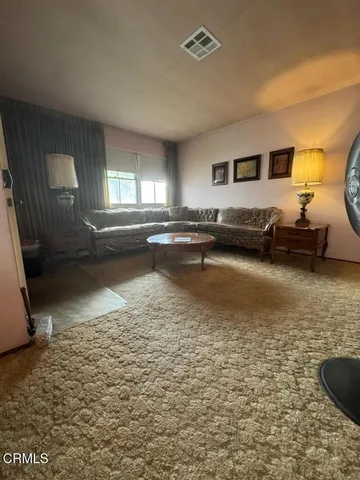 a view of a living room and kitchen