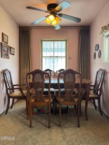 a view of a dining room with furniture and chandelier