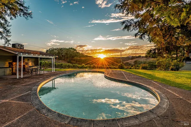 a living room with furniture chandelier and a fireplace