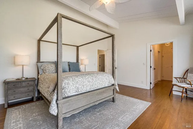 a bed sitting in a bedroom next to a window