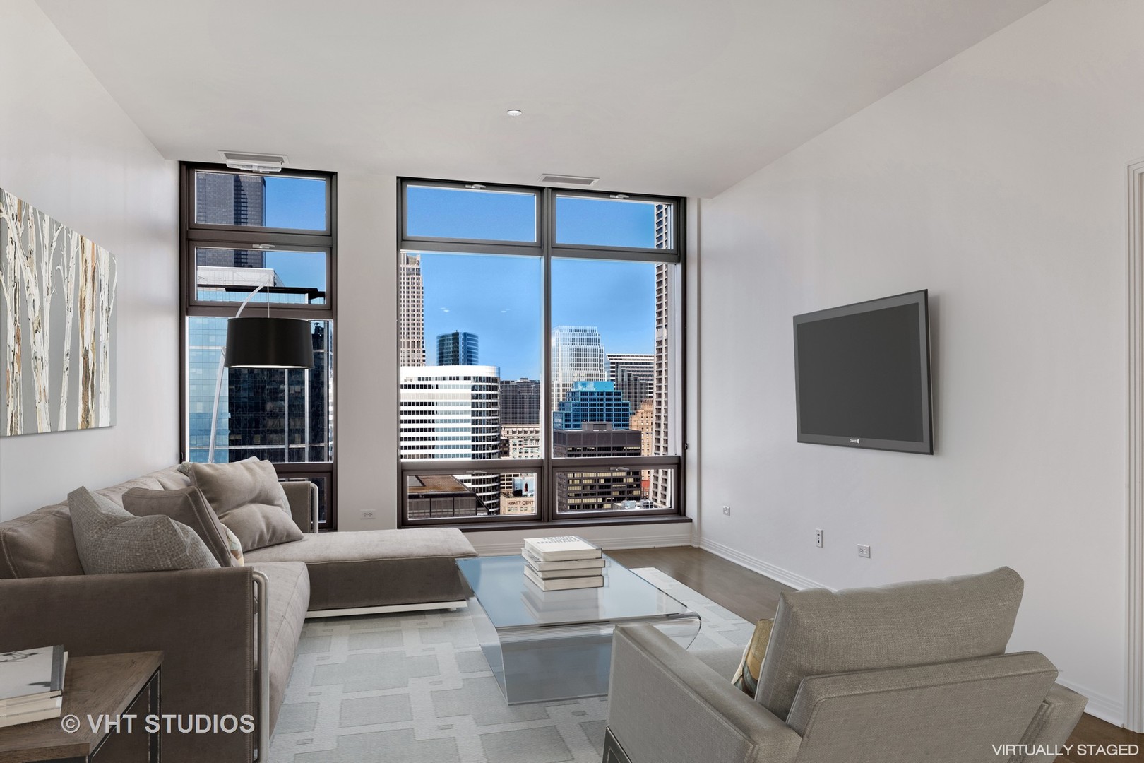 65 East Monroe Street, Unit 4015 Chicago, IL 60603 - Photo 3 of 14 a living room with furniture and a flat screen tv