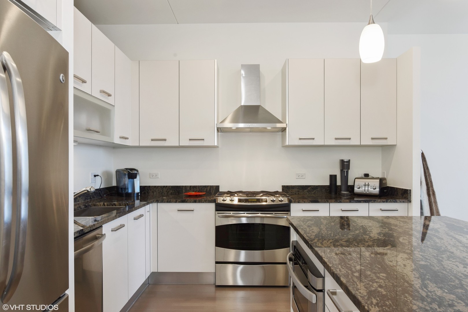 65 East Monroe Street, Unit 4015 Chicago, IL 60603 - Photo 4 of 14 a kitchen with granite countertop a sink a stove and cabinets