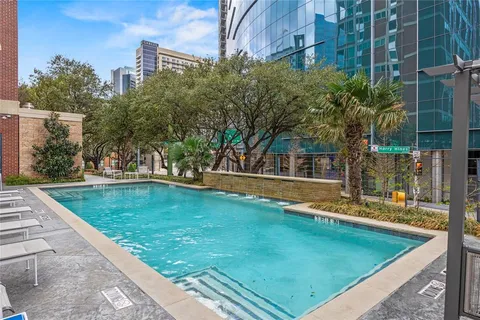 a view of a swimming pool with a yard