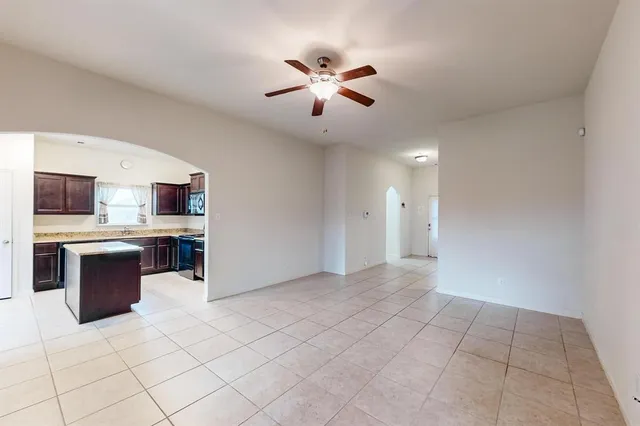 a view of kitchen with stainless steel appliances kitchen island granite countertop a stove top oven a sink a dining table and chairs