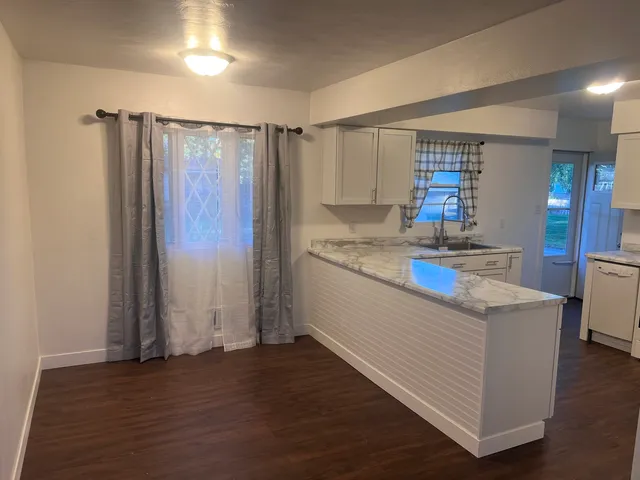 a kitchen with stainless steel appliances granite countertop a sink and a refrigerator
