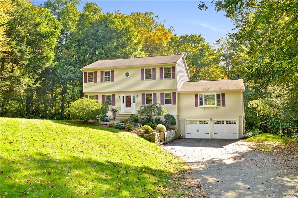 466 Yellow Brick Road Orange, CT 06477 - Photo 1 of 1 a front view of a house with a yard