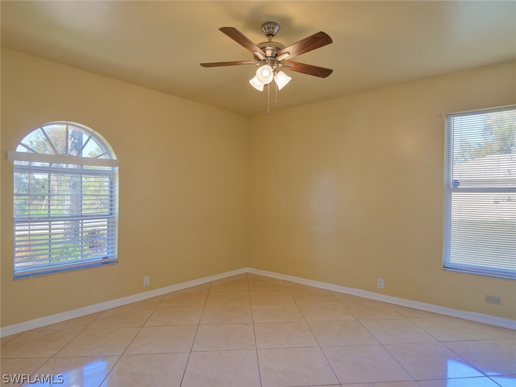 17525 Lee Road Fort Myers, FL 33967 - Photo 11 of 24 an empty room with windows and fan