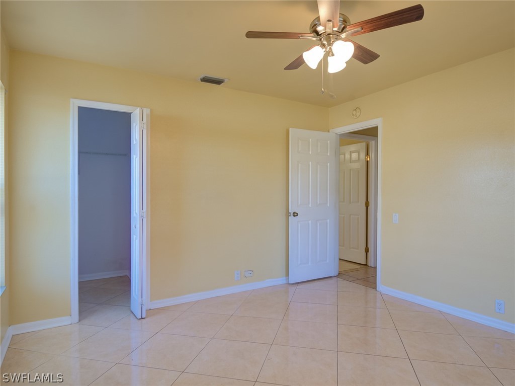17525 Lee Road Fort Myers, FL 33967 - Photo 12 of 24 a view of an empty room with a fan