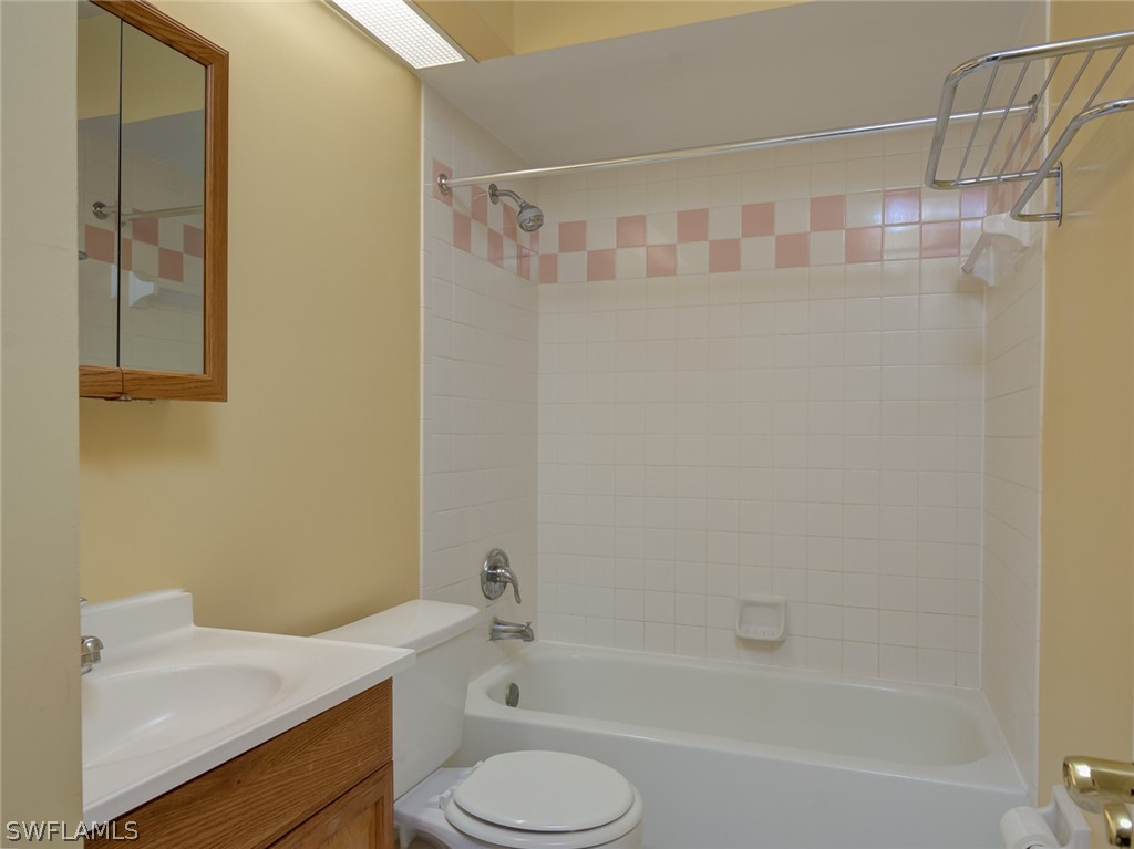 17525 Lee Road Fort Myers, FL 33967 - Photo 13 of 24 a bathroom with a shower curtain and a sink