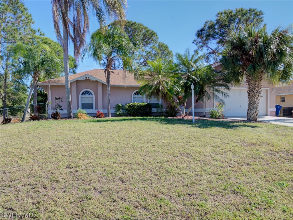 17525 Lee Road Fort Myers, FL 33967 - Photo 18 of 24 a front view of house with yard and trees