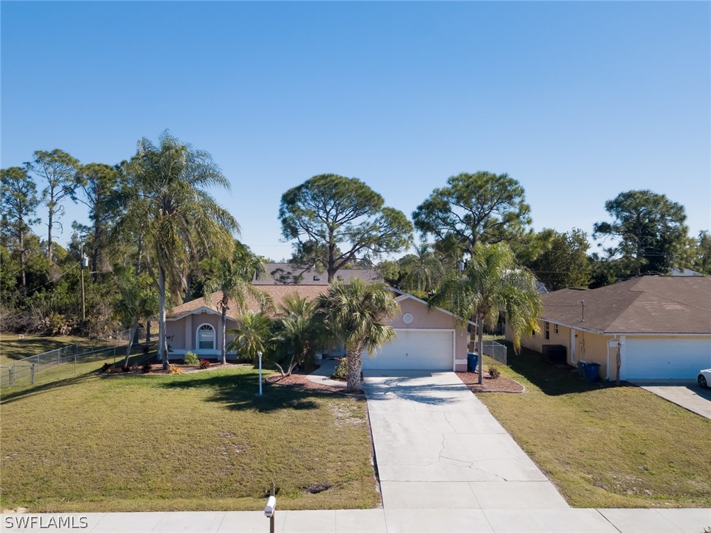 17525 Lee Road Fort Myers, FL 33967 - Photo 2 of 24 a swimming pool with outdoor seating and yard