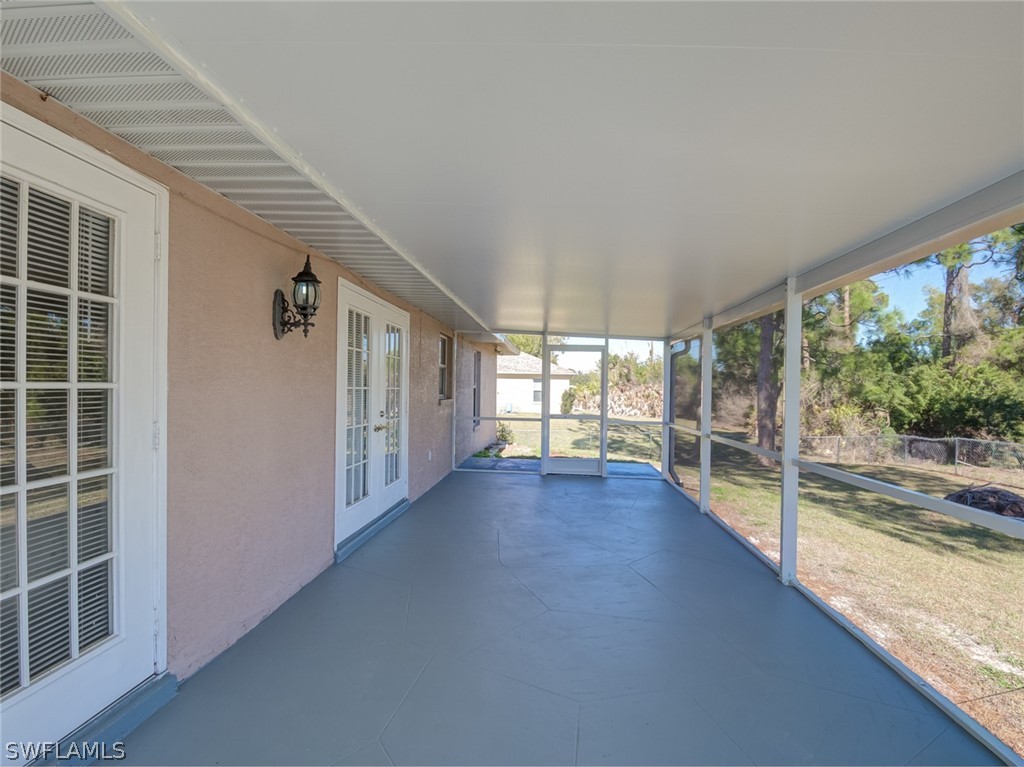 17525 Lee Road Fort Myers, FL 33967 - Photo 21 of 24 wooden floor in an empty room with a window