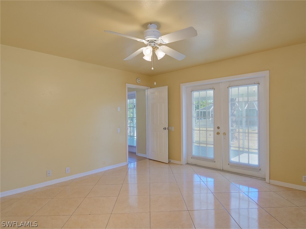 17525 Lee Road Fort Myers, FL 33967 - Photo 8 of 24 a view of an empty room with window and chandelier fan