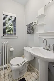 a bathroom with a sink a toilet and a mirror