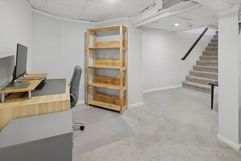 a view of workspace with furniture and stairs