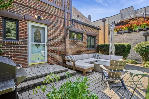 a view of a patio with table and chairs and potted plants