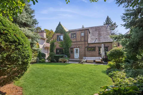 a view of a house with a yard and sitting area