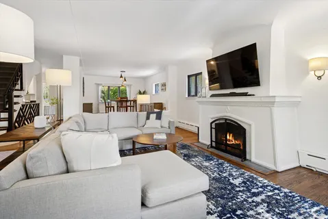 a living room with furniture a flat screen tv and a fireplace