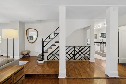 a view of a large kitchen with a sink and a refrigerator with wooden floor