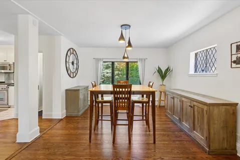 a view of a dining room with furniture window and wooden floor