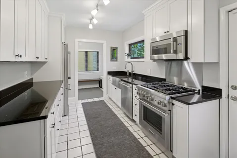 a kitchen with stainless steel appliances a stove a microwave and cabinets