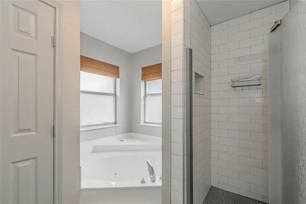 a bathroom with a bathtub and shower