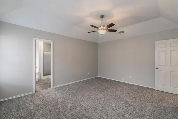 a view of an empty room with a ceiling fan