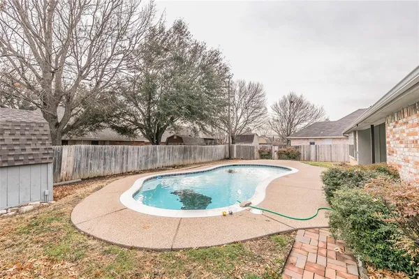 a view of a swimming pool with back yard