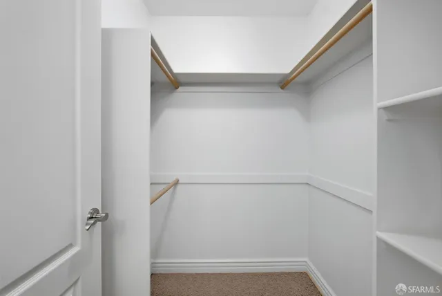 a bathroom with a granite countertop sink a toilet and a mirror
