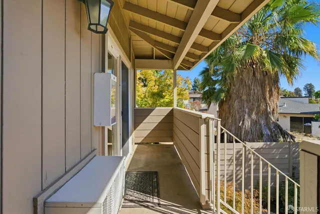 an aerial view of a house with a yard and a large tree