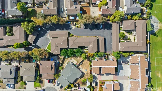 an aerial view of residential houses with outdoor space and river view