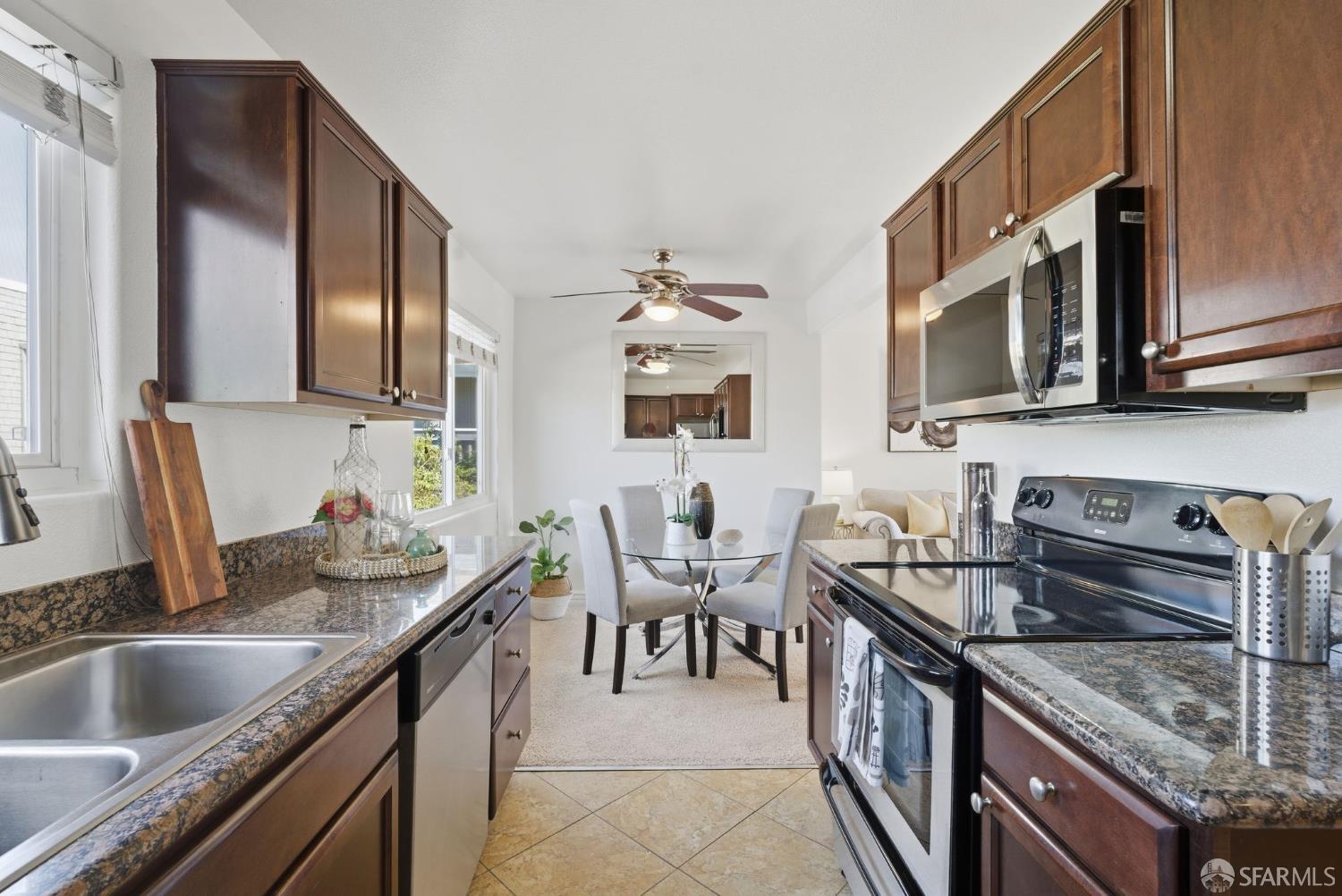 4970 Cherry Avenue, Unit 211 San Jose, CA 95118 - Photo 10 of 67 a kitchen with granite countertop a sink stove and cabinets