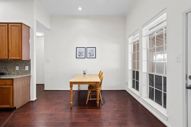 a dining room with furniture and wooden floor