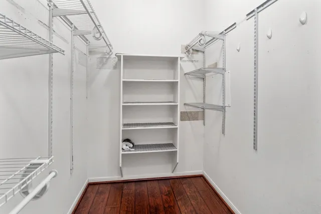 a view of walk in closet with empty racks