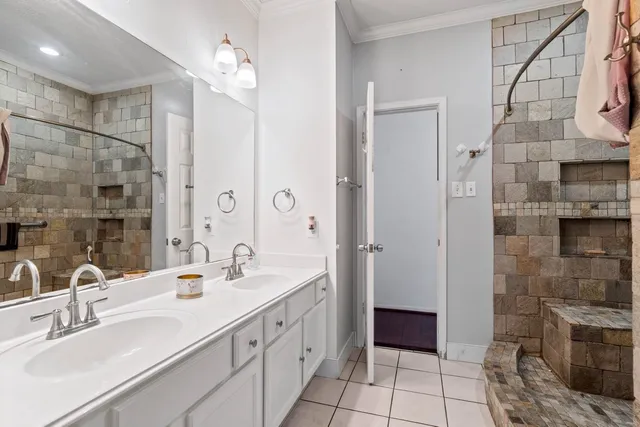 a bathroom with a double sink shower and a mirror