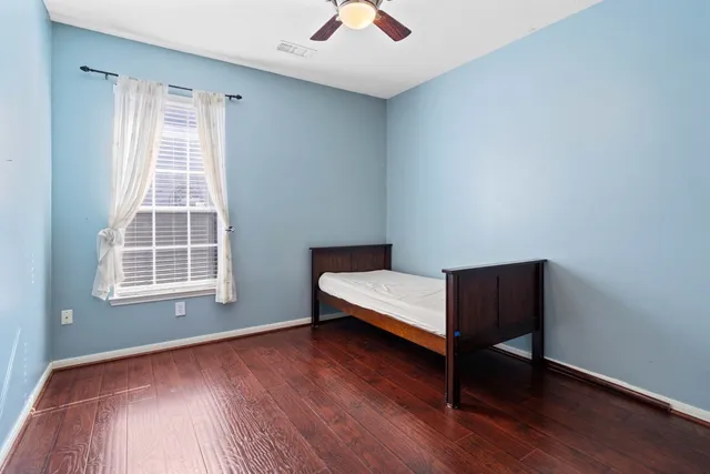 a bedroom with bed and a window