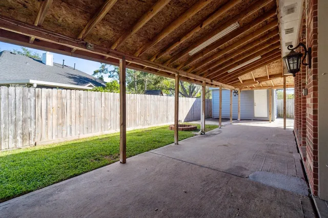 a view of backyard with wooden fence