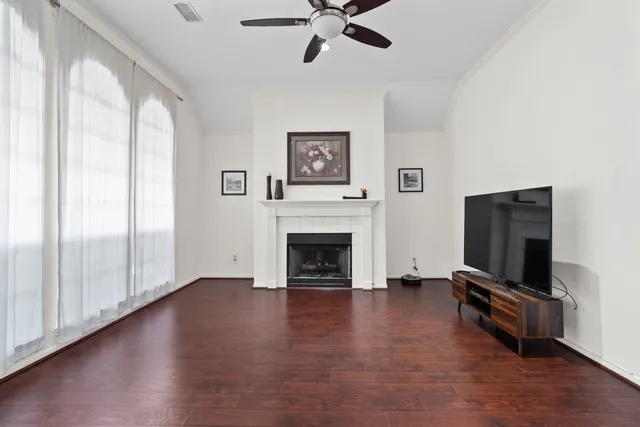 a living room with furniture fireplace and flat screen tv