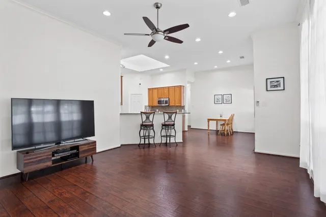 a living room with furniture and wooden floor