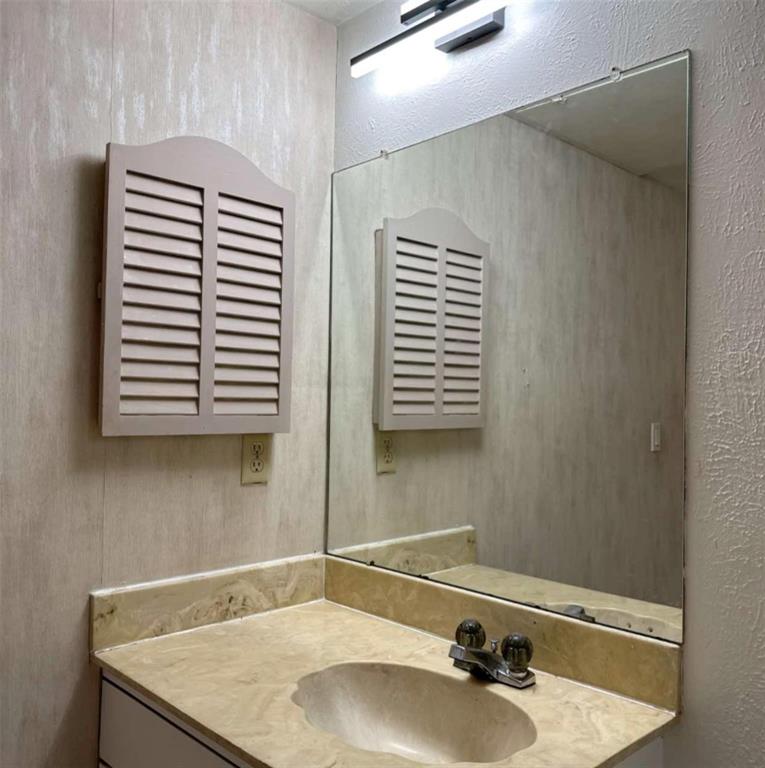 4845 Cedar Springs Road, Unit 267 Dallas, TX 75219 - Photo 17 of 17 a bathroom with a sink and a mirror