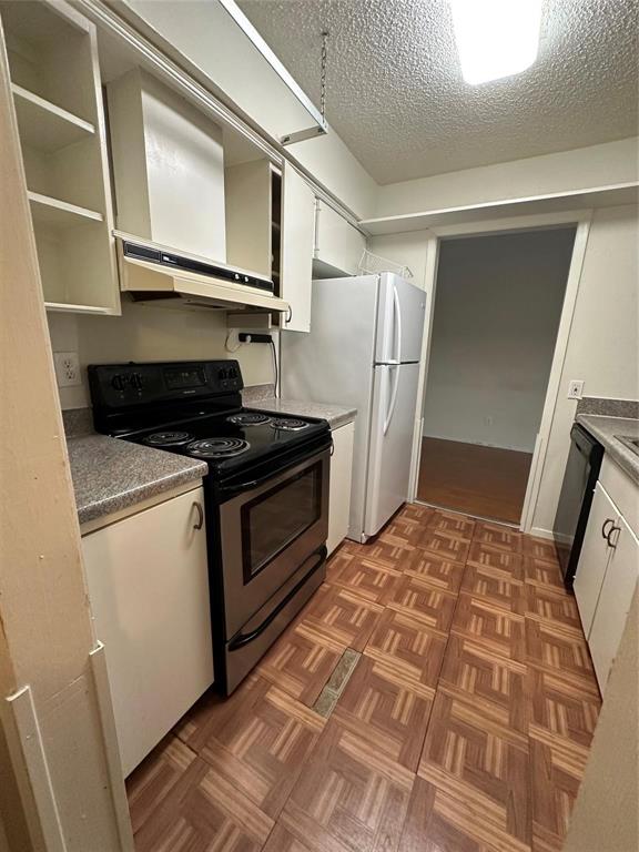 4845 Cedar Springs Road, Unit 267 Dallas, TX 75219 - Photo 2 of 17 a kitchen with a refrigerator and a stove