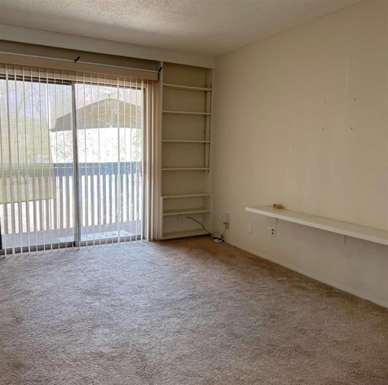 4845 Cedar Springs Road, Unit 267 Dallas, TX 75219 - Photo 7 of 17 wooden floor and window in an empty room