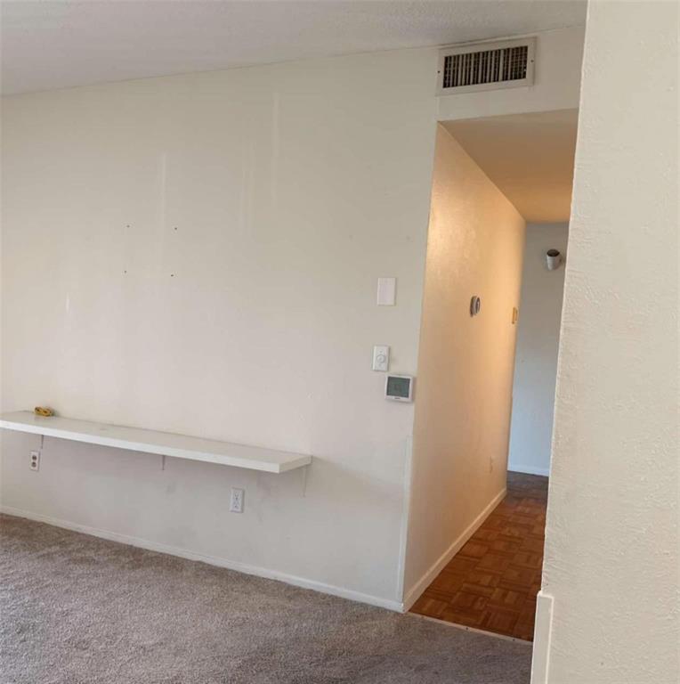 4845 Cedar Springs Road, Unit 267 Dallas, TX 75219 - Photo 8 of 17 an empty room with a bench