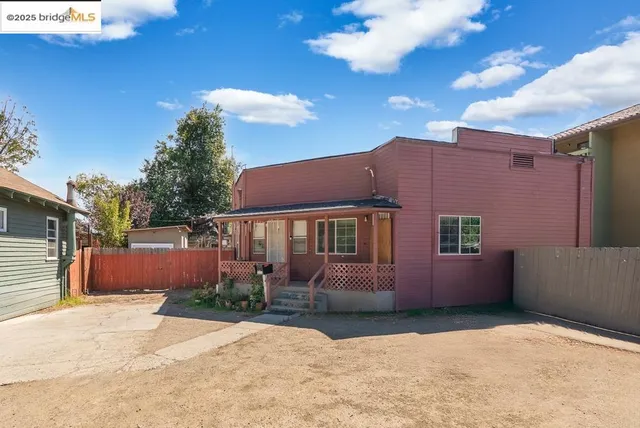 a backyard of a house with yard and outdoor seating