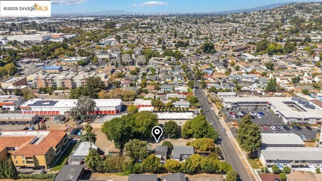 an aerial view of residential houses with city view
