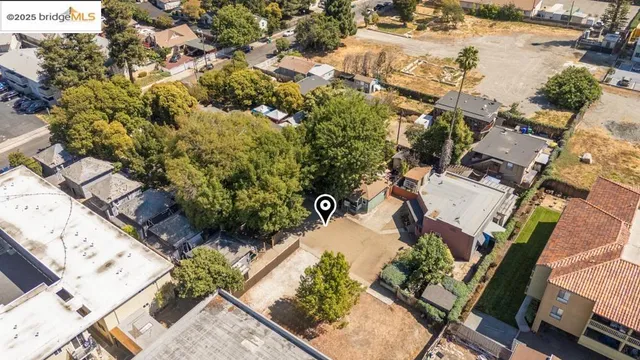 an aerial view of a house with a yard and lake view
