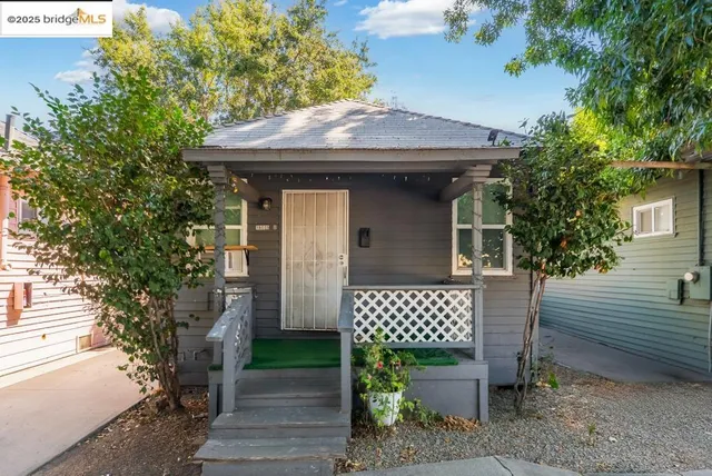 a view of a wooden house with a bench and chair