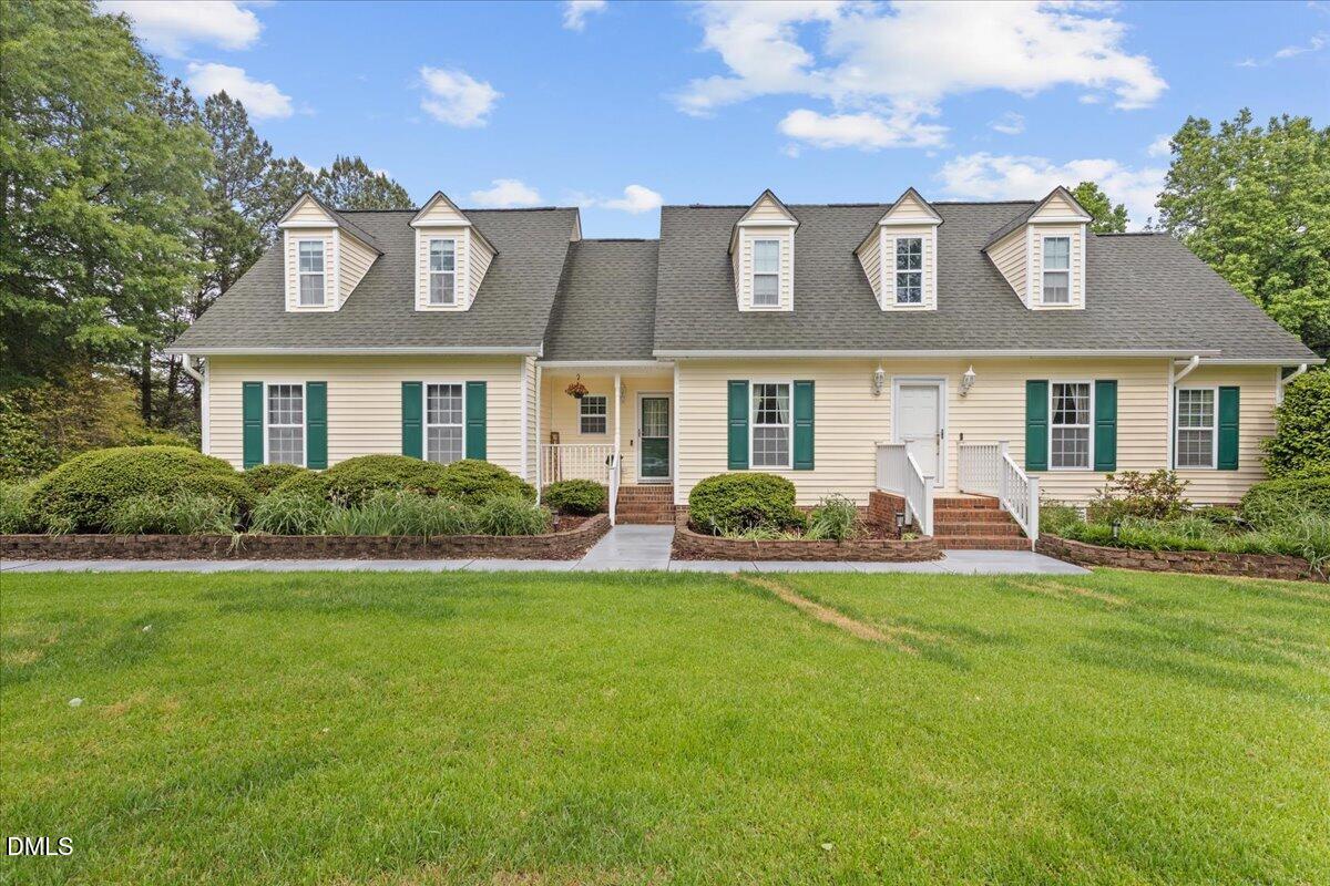 4317 South Mountain Drive Raleigh, NC 27603 - Photo 1 of 57 a front view of a house with a yard table and chairs